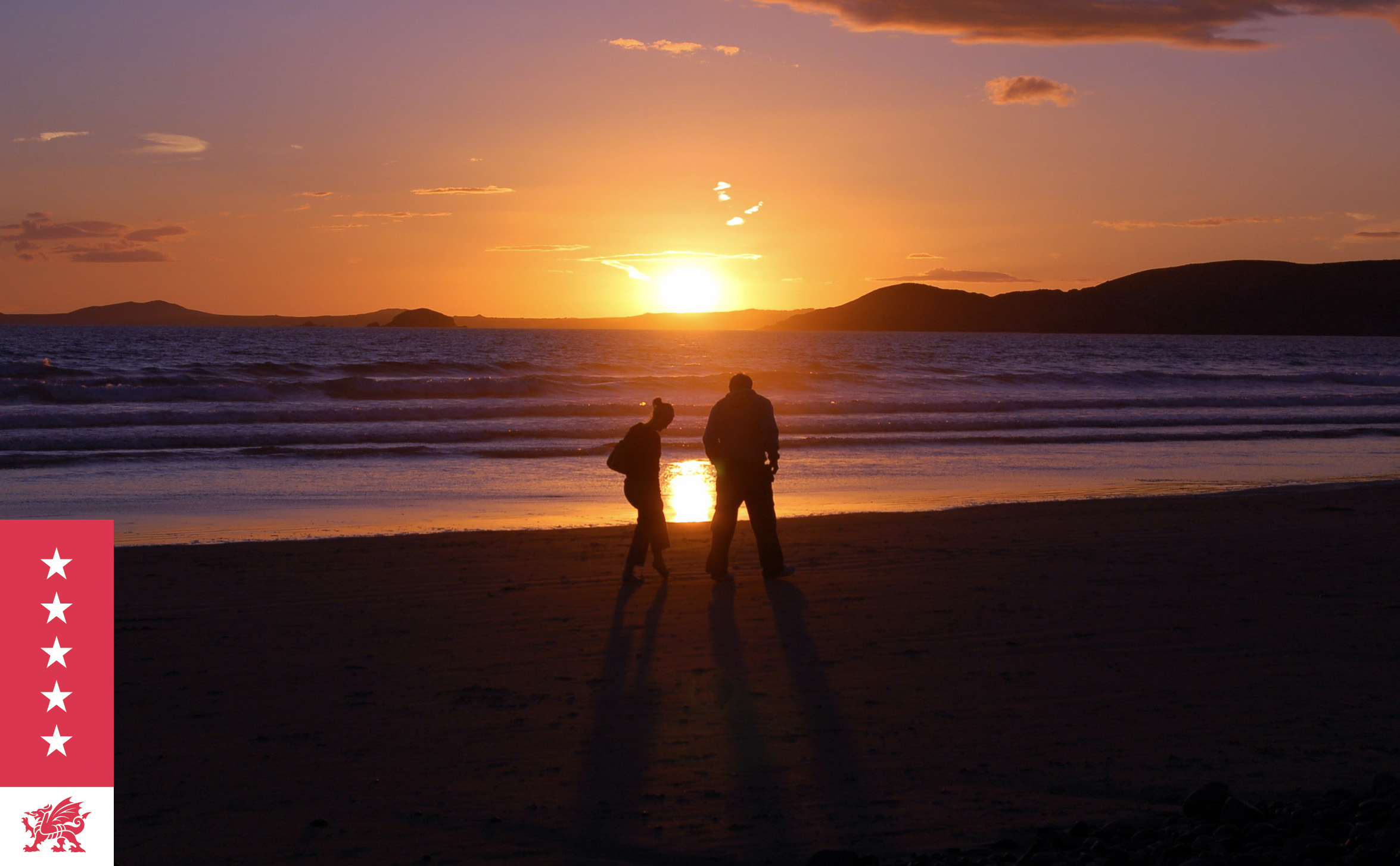 Couple taking a romantic sunset walk along the beach